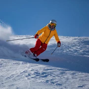 Skiers in Bakuriani surrounded by snow and mountain views