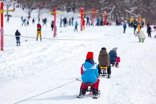 Children enjoying winter fun and sledding in Bakuriani